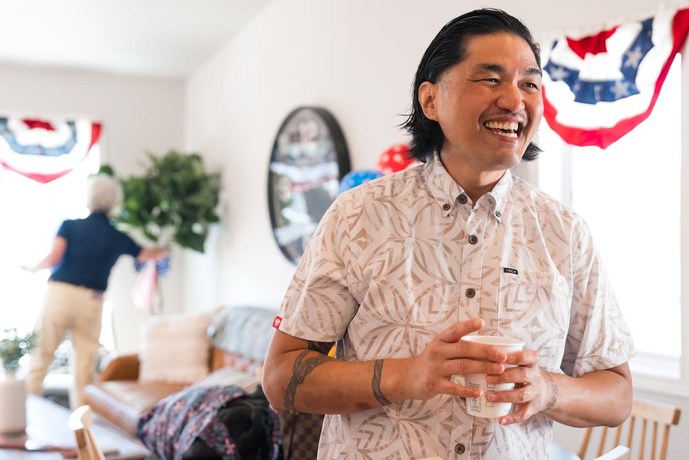 Photo of smiling man standing in his new home