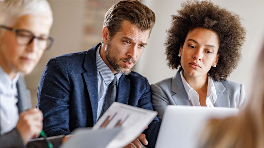 Group of professionals looking at liquidity charts in a meeting