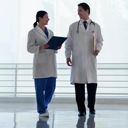 Two doctors walking down a hallway
