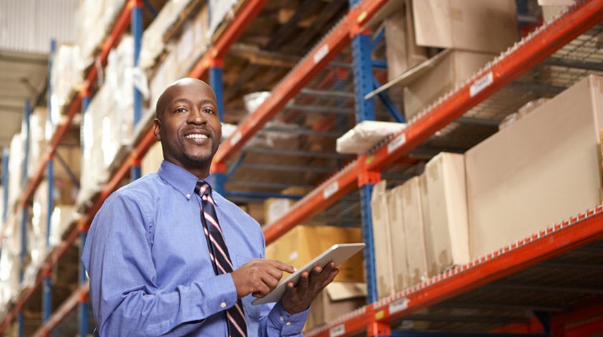 Man wearing a tie standing in a warehouse