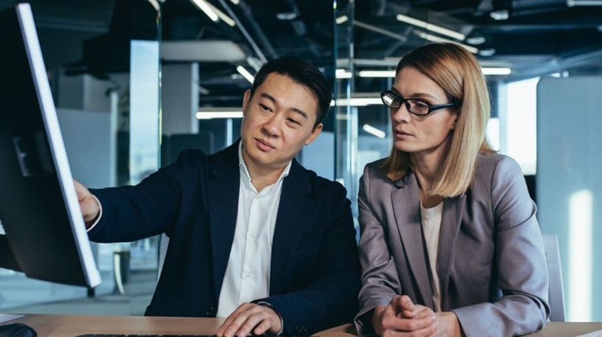 Professional man and woman sitting together discussing currency conversion
