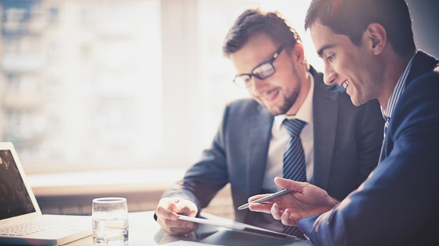 Two men in suits discussing AI in finance
