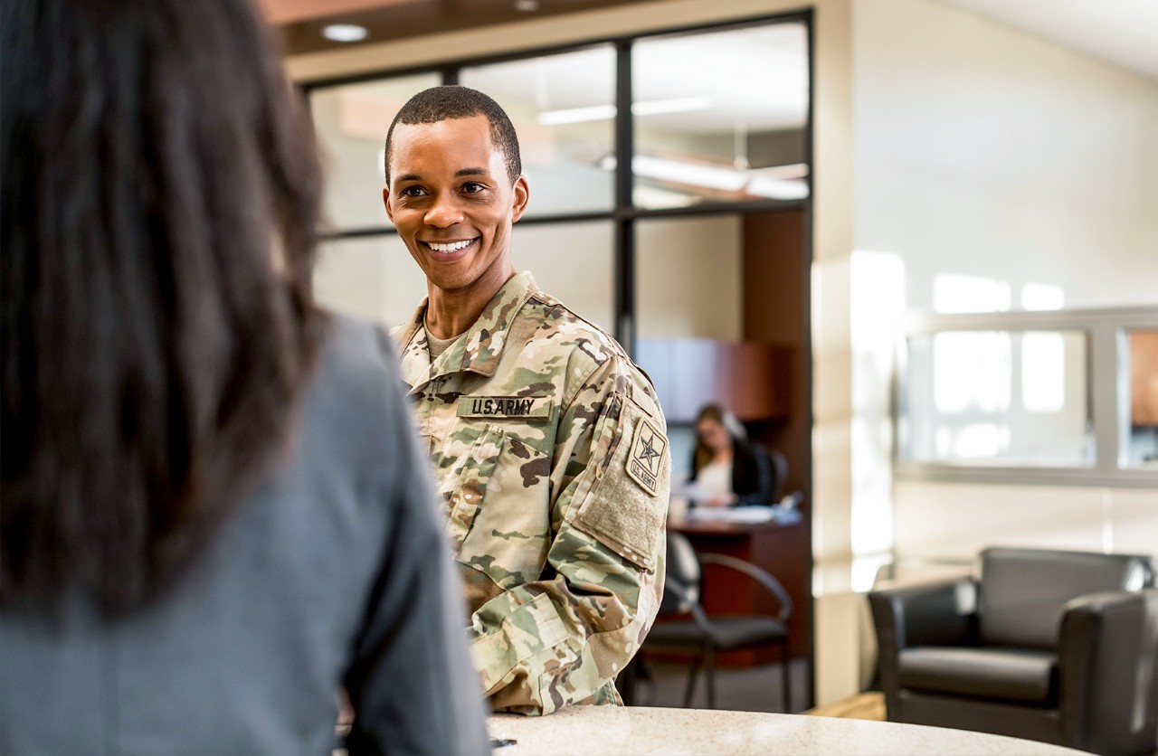 Uniformed active duty servicemember opening a military checking account inside a Valzure Private Bank branch