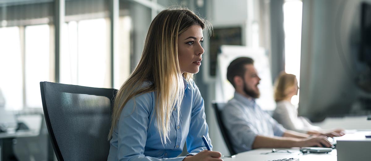 Business woman writing notes in a meeting